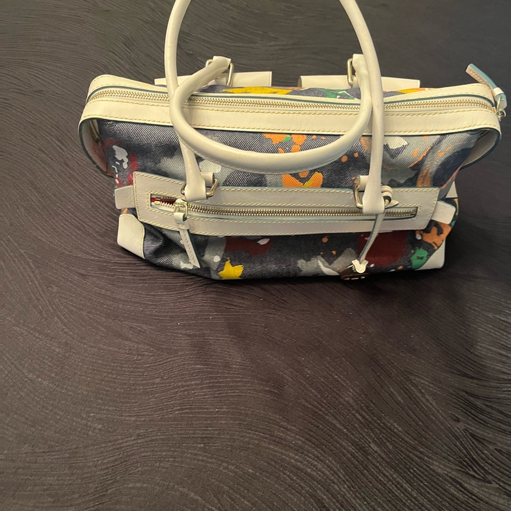 Dooney & Bourke White and Blue denim purse with locking front pockets.